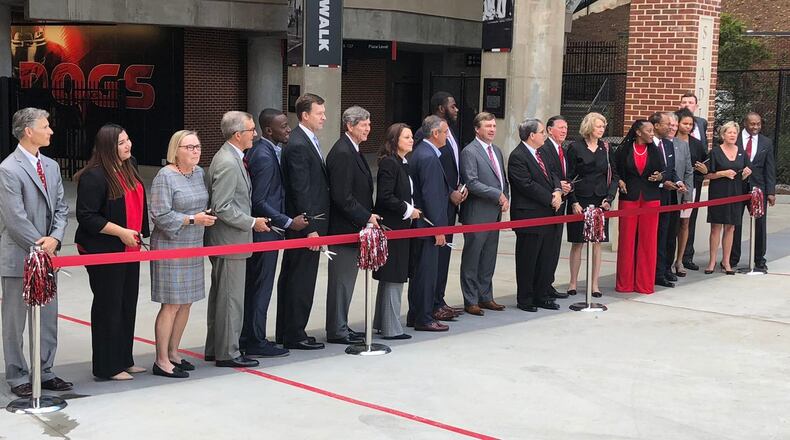 Georgia coach Kirby Smart (middle, gray suit) poses with next to UGA President Jere More head and members of the UGA Athletic Association board of directors during the dedication ceremony of the West End renovation project at Sanford Stadium in 2018. (Photo by Chip Towers/ctowers@ajc.com)