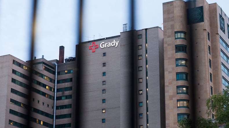 Grady Memorial Hospital, seen through metal bars of a fence, stands in downtown Atlanta, Monday, June 1, 2015.  BRANDEN CAMP/SPECIAL