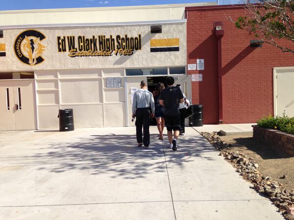 Georgia Tech coach Josh Pastner (right) and Texas coach Shaka Smart walk together into Clark High School in Las Vegas to watch an AAU tournament game July 27, 2017.