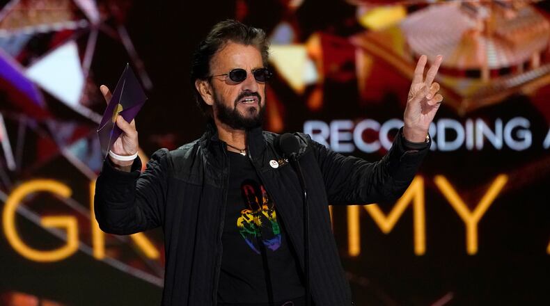 Ringo Starr gestures as he presents the award for record of the year at the 63rd annual Grammy Awards at the Los Angeles Convention Center on Sunday, March 14, 2021. (AP Photo/Chris Pizzello)