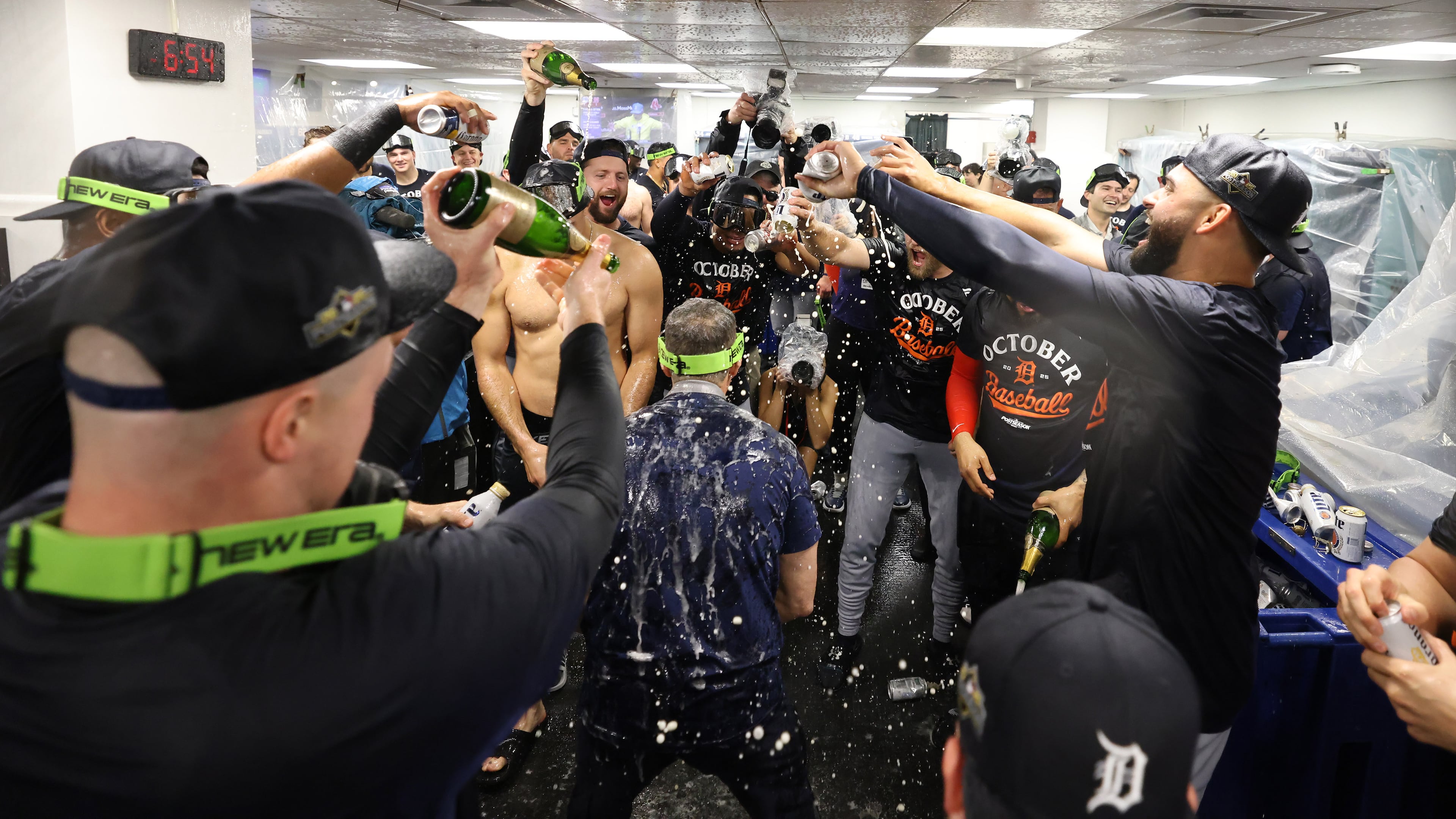 The Detroit Tigers celebrate in the locker room after defeating the Boston Red Sox and clinching a spot in the playoffs, Saturday, Sept. 27, 2025, in Boston. (AP Photo/Mark Stockwell)