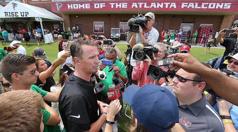 Falcons QB Matt Ryan is surrounded by members of the media during last summer's training camp in Flowery Branch.
