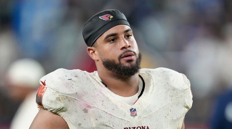 FILE - Arizona Cardinals guard Isaiah Adams walks off the field after an NFL football game against the Seattle Seahawks, Sept. 25, 2025, in Glendale, Ariz. (AP Photo/Ross D. Franklin, File)