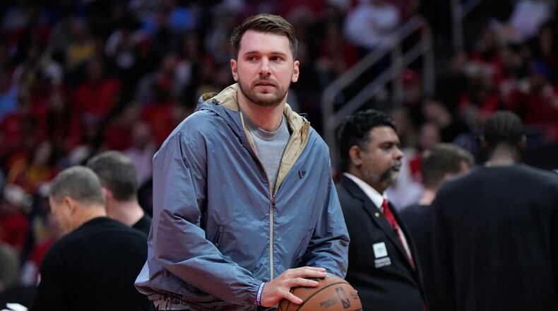 Los Angeles Lakers guard Luka Doncic holds a ball during a timeout in the first half of Game 6 of a first-round NBA playoffs basketball series against the Houston Rockets in Houston, Friday, May 1, 2026. (AP Photo/Ashley Landis)