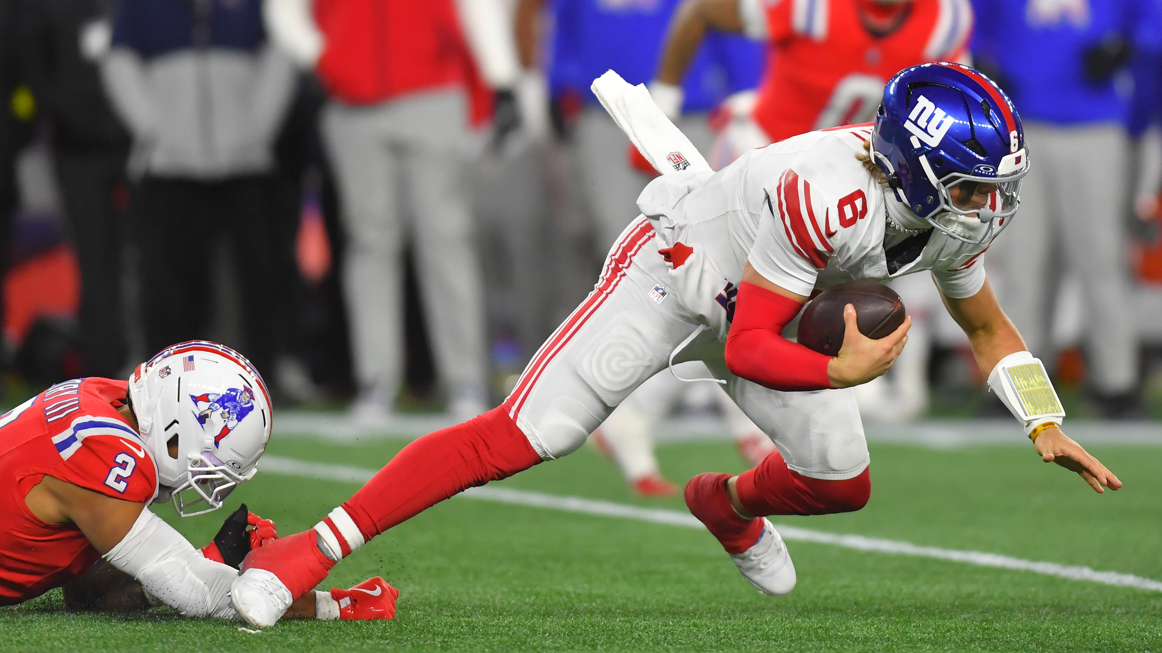 New York Giants quarterback Jaxson Dart (6) is sacked by New England Patriots linebacker Harold Landry III (2) during the second half of an NFL football game Monday, Dec. 1, 2025, in Foxborough, Mass. (AP Photo/Steven Senne)