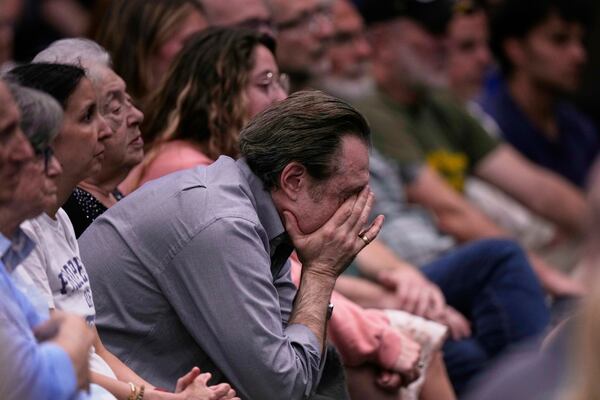 People at the Jewish Community Center of Greater Kansas City mourn Sarah Milgrim and Yaron Lischinsky, Israeli Embassy staff members who were shot and killed while leaving an event at a Jewish museum in Washington, Thursday, May 22, 2025, in Overland Park, Kan. (AP Photo/Charlie Riedel)