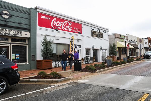 People walk down the sidewalk in downtown Hampton, Ga., on Saturday, Feb. 21, 2026. (Abbey Cutrer/AJC)