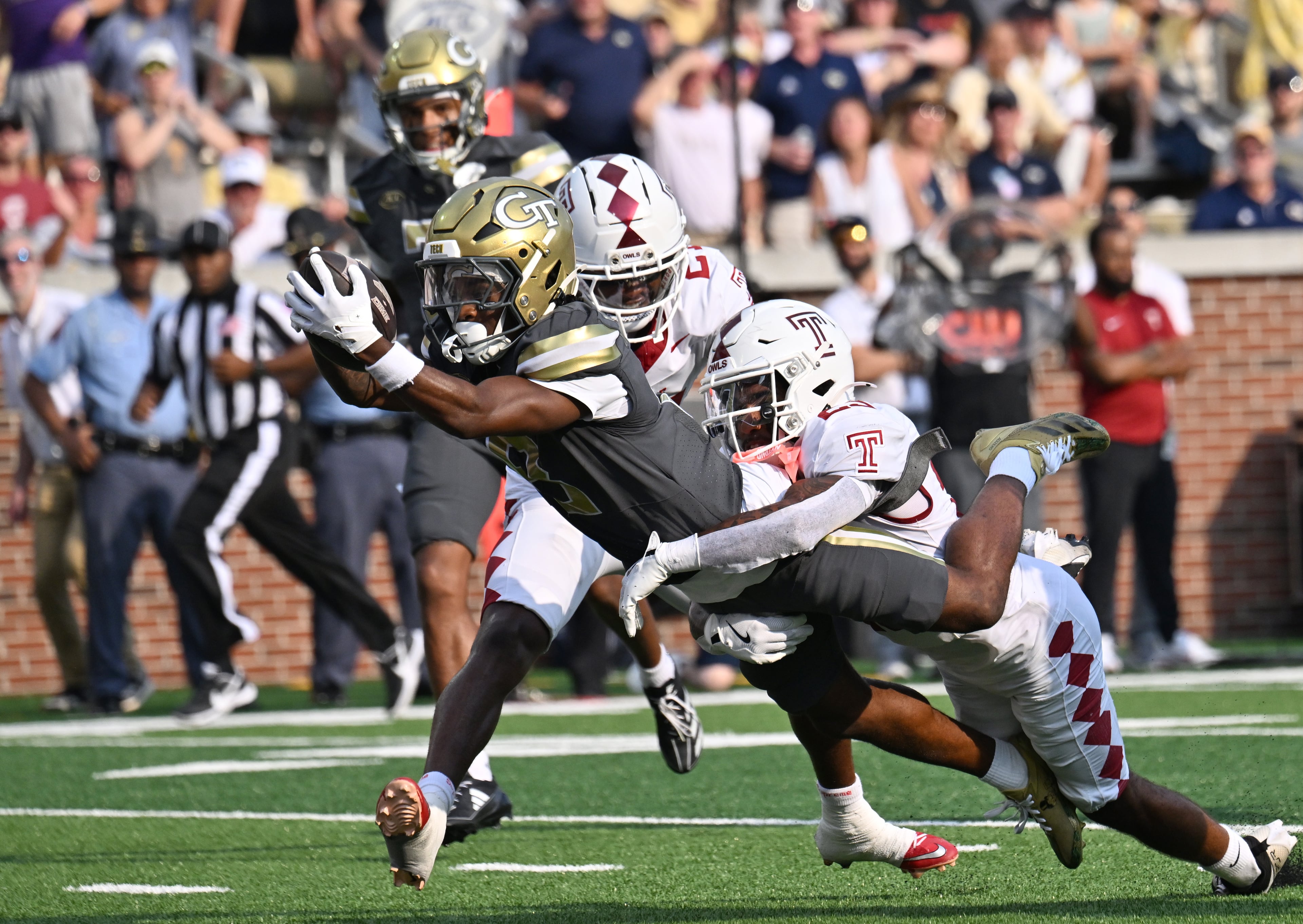 Georgia Tech wide receiver Malik Rutherford dives past Temple safety Avery Powell into the end zone for a touchdown during the first half against Temple at Bobby Dodd Stadium on Saturday, Sept. 20, 2025, in Atlanta. (Hyosub Shin/AJC)
