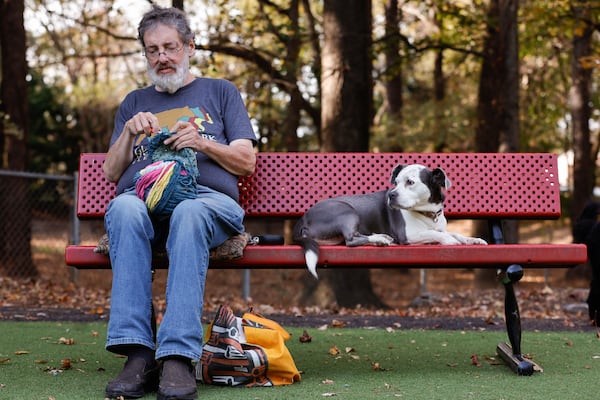 Penn Collins sits with his crochet quality control partner, Josephine. 