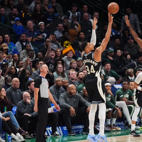 Milwaukee Bucks forward Giannis Antetokounmpo (34) shoots a three-pointer against Dallas Mavericks center Moussa Cisse (30) during the second half of an NBA basketball game in Dallas, Monday, Nov. 10, 2025. (AP Photo/LM Otero)