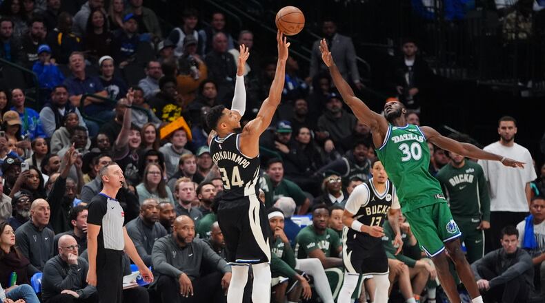 Milwaukee Bucks forward Giannis Antetokounmpo (34) shoots a three-pointer against Dallas Mavericks center Moussa Cisse (30) during the second half of an NBA basketball game in Dallas, Monday, Nov. 10, 2025. (AP Photo/LM Otero)