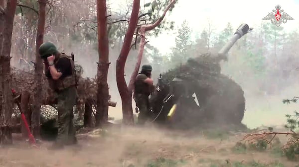 In this photo taken from a video released by the Russian Defense Ministry on Wednesday, July 9, 2025, Russian soldiers fire from D-30 howitzer towards Ukrainian positions in an undisclosed location in Ukraine. (Russian Defense Ministry Press Service via AP)