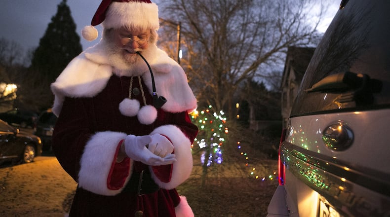 Judge T. Jackson Bedford prepares for his grand entrance as Santa Claus at a friend’s house Christmas party in Smyrna. CASEY SYKES / FOR THE ATLANTA JOURNAL-CONSTITUTION