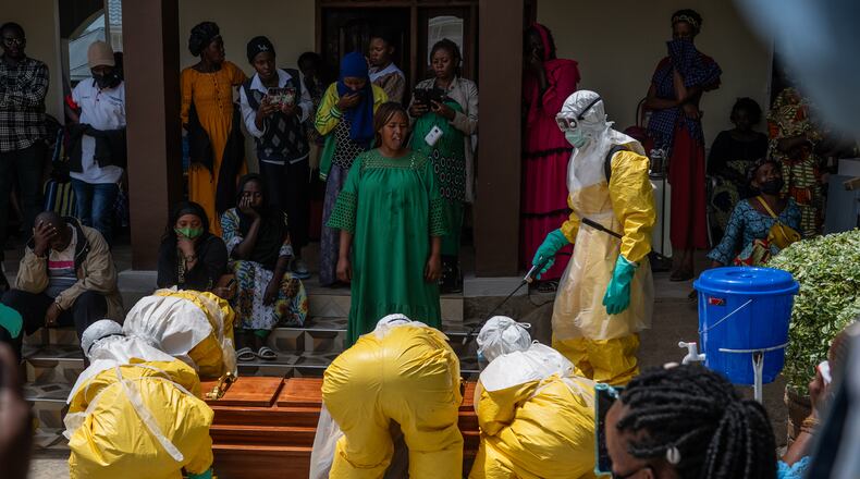 Family members of an Ebola victim mourn as the coffin is taken away for burial, at Sofepadi Hospital in Bunia, Congo, Saturday, May 23, 2026. (AP Photo/Moses Sawasawa)