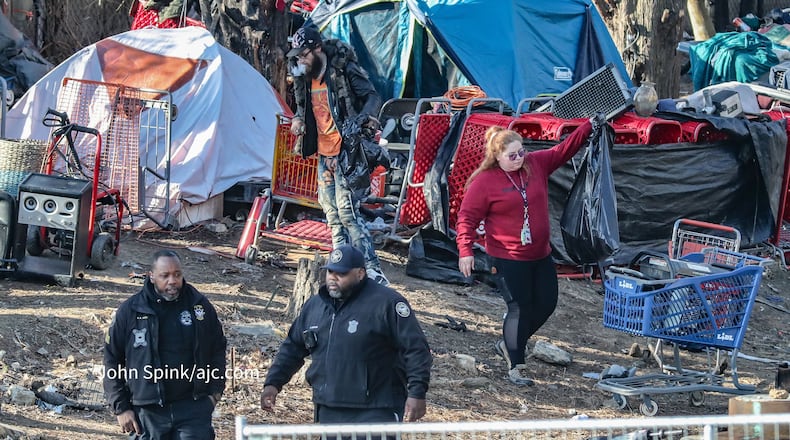 Atlanta Police and GDOT personnel clear a homeless encampment Monday.
