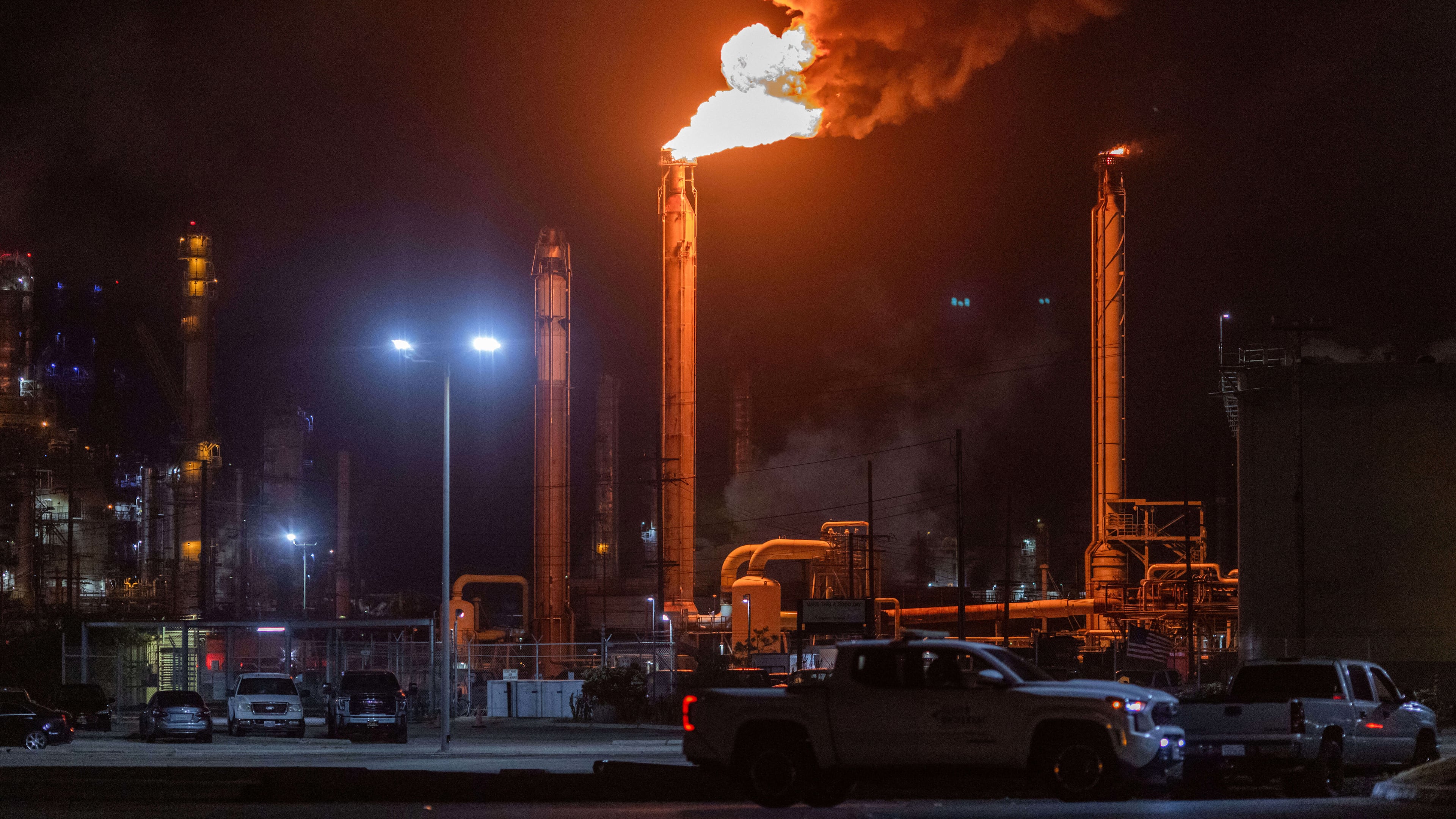Flames rise from the Chevron refinery in El Segundo, Calif., Thursday, Oct. 2, 2025. (AP Photo/Ethan Swope)