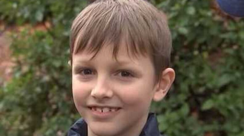 Ezra Zyskowski, 10, who was seated in the back seat, was able to escape before the thieves drove away from the home, police said. (Credit: Channel 2 Action News)