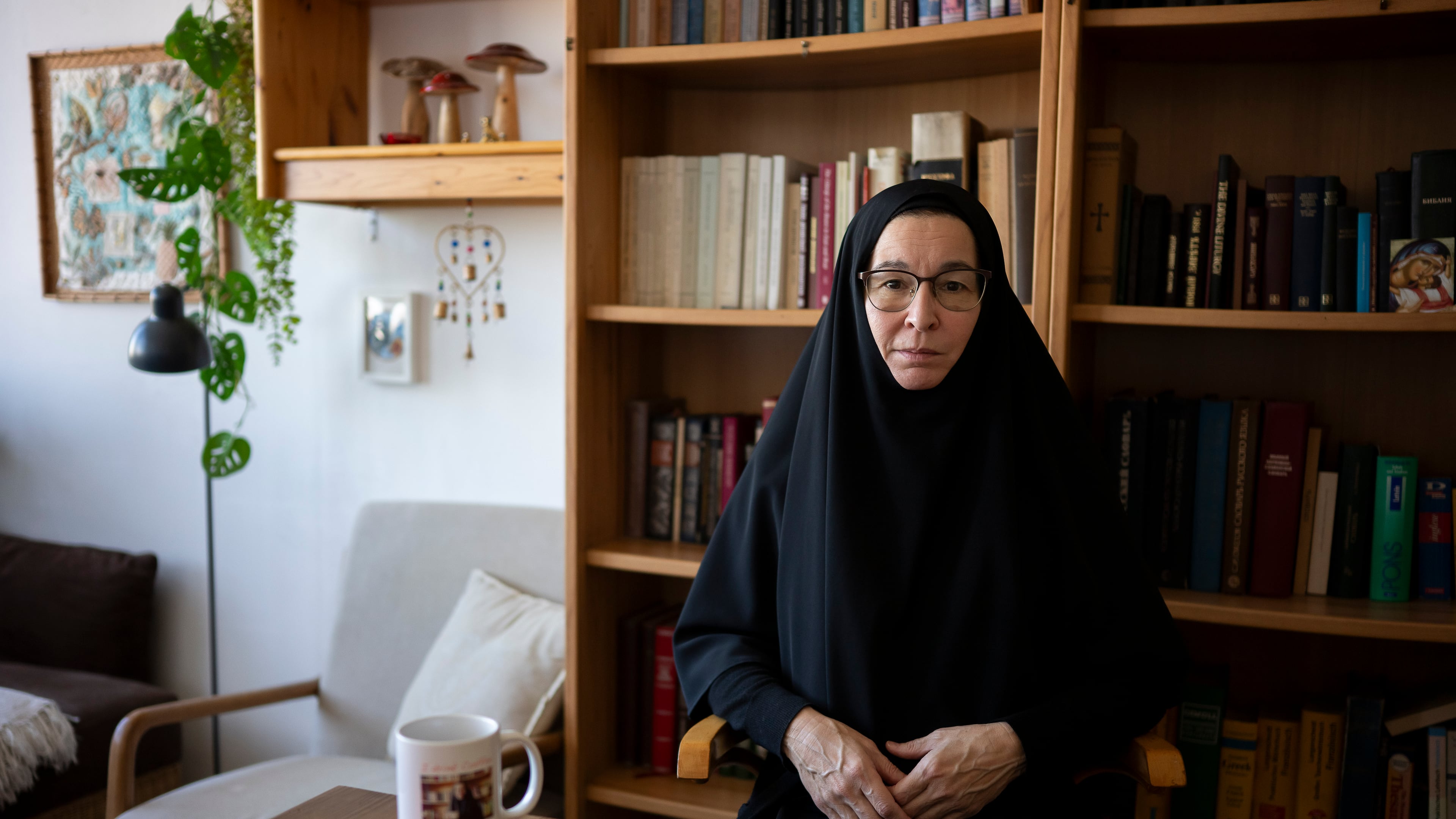 Sister Vassa Larin, a prominent American Orthodox nun, public speaker and YouTube presenter, poses for a portrait for the Associated Press in her room before recording one of her videos in Vienna, Austria, on Wednesday, Sept 3. 2025. (AP Photo/Denes Erdos)