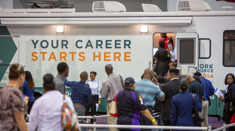 A low unemployment rate means most people who want jobs can eventually find one, but at any moment, many tens of thousands of Georgians are out of work and looking for their next position. Here, job seekers registered at a job fair held Oct. 8 at the Georgia International Convention Center. (Photo by Phil Skinner)