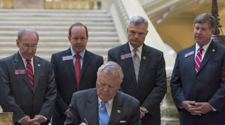 Gov. Nathan Deal signs the First Priority Act, aimed at aiding low-performing schools, in Atlanta on April 27, 2017. (DAVID BARNES / DAVID.BARNES@AJC.COM)