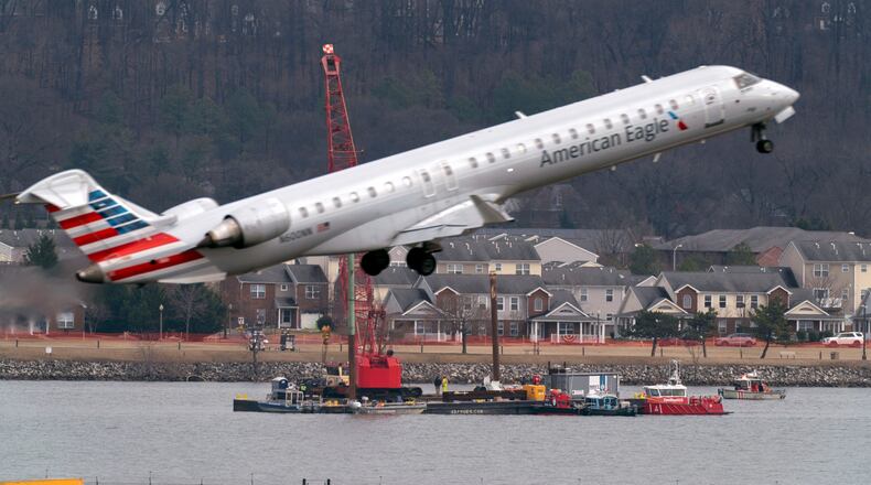FILE - Salvage crews work on recovering wreckage near the site in the Potomac River of a mid-air collision between an American Airlines jet and a Black Hawk helicopter at Ronald Reagan Washington National Airport, Feb. 6, 2025, in Arlington, Va. (AP Photo/Jose Luis Magana, File)