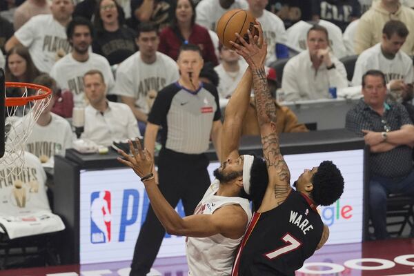 Cleveland Cavaliers center Jarrett Allen (31) is defended by Miami Heat center Kel'el Ware (7) in the first half in Game 2 of an NBA first-round playoff series, Wednesday, April 23, 2025, in Cleveland. (AP Photo/Sue Ogrocki)
