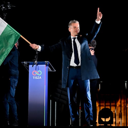 Peter Magyar, leader of the opposition Tisza party, waves the Hungarian flag following the announcement of the partial results of the parliamentary election, in Budapest, Hungary, Sunday, April 12, 2026. (AP Photo/Denes Erdos)