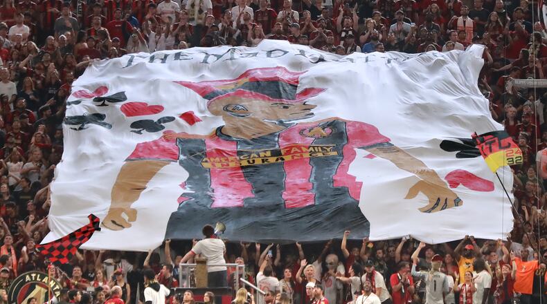 Atlanta United fans hoist a tifo of Josef Martinez, who tied the MLS season scoring record with his 27th goal in Sunday’s win. Curtis Compton/ccompton@ajc.com