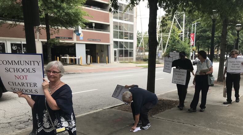 A protest organized by the Georgia Federation of Teachers took place outside the Atlanta Public Schools headquarters on Thursday. VANESSA McCRAY/AJC