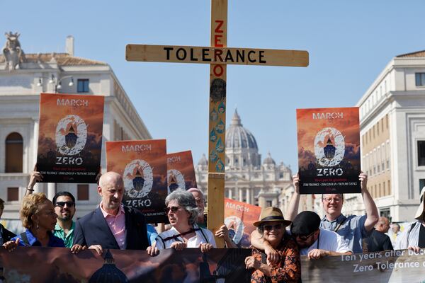 FILE - From left, survivor-activists psychoneurologist Denise Buchanan, psychotherapist Peter Isely, Kazlaw Injury & Trauma Lawyers' support team specialist Leona Huggins and president of Ending Clergy Abuse Timothy Law hold a wooden cross as they arrive at the Vatican, Sept. 27, 2023, at the end of their pilgrimage to protest the pope's failure to end clergy abuse. (AP Photo/Riccardo De Luca, File)
