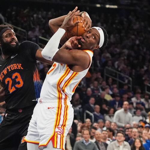 The Hawks' Nickeil Alexander-Walker (right) fights for control of the ball with the Knicks' Mitchell Robinson (center) during Game 5 of the first-round playoff series April 28, 2026, in New York. (Frank Franklin II/AP)