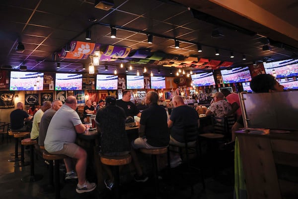 Woofs owner Gregory Hughes says the Pride House designation was “an honor.” And World Cup watch parties have helped boost sales at the bar.  (Miguel Martinez/AJC)