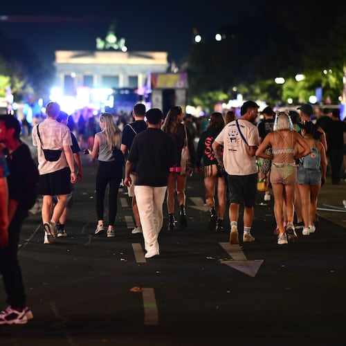 People stand on 17 June Street following the cancellation of Christopher Street Day in Berlin, on Saturday, July 25, 2026. (Fabian Sommer/dpa via AP)