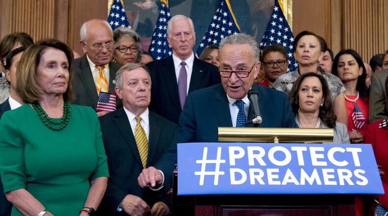 Senate Minority Leader Chuck Schumer of N.Y., accompanied by House Minority Leader Nancy Pelosi of Calif., left, and other Democratic members of the House and Senate, speaks during a Capitol Hill press conference in Washington earlier this month. AP/Jose Luis Magana