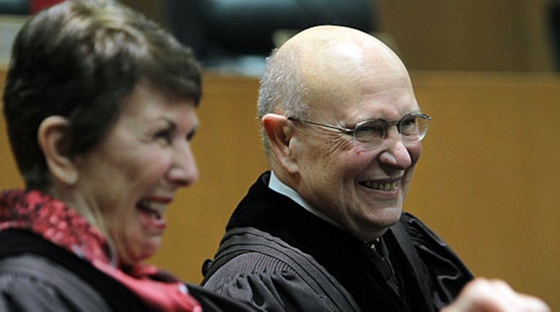 Chief Justice Carol Huntstein (left) and Justice George Carley share a moment of laughter when the honorable Willis Hunt Jr., senior judge, United States District Court of the Northern District, Georgia, delivers the introduction of Justice Carley to a standing room only courtroom.