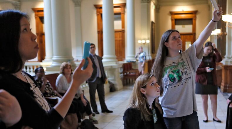 Mar. 1 2017 - Atlanta - Grace Starling (seated) joins other advocates from “Students Against House Bill 51” who are watching and live streaming the video feed of the proceedings in the house during debate of HB 51. Rep. Earl Ehrhart, R - Powder Springs, presented House Bill 51. BOB ANDRES /BANDRES@AJC.COM
