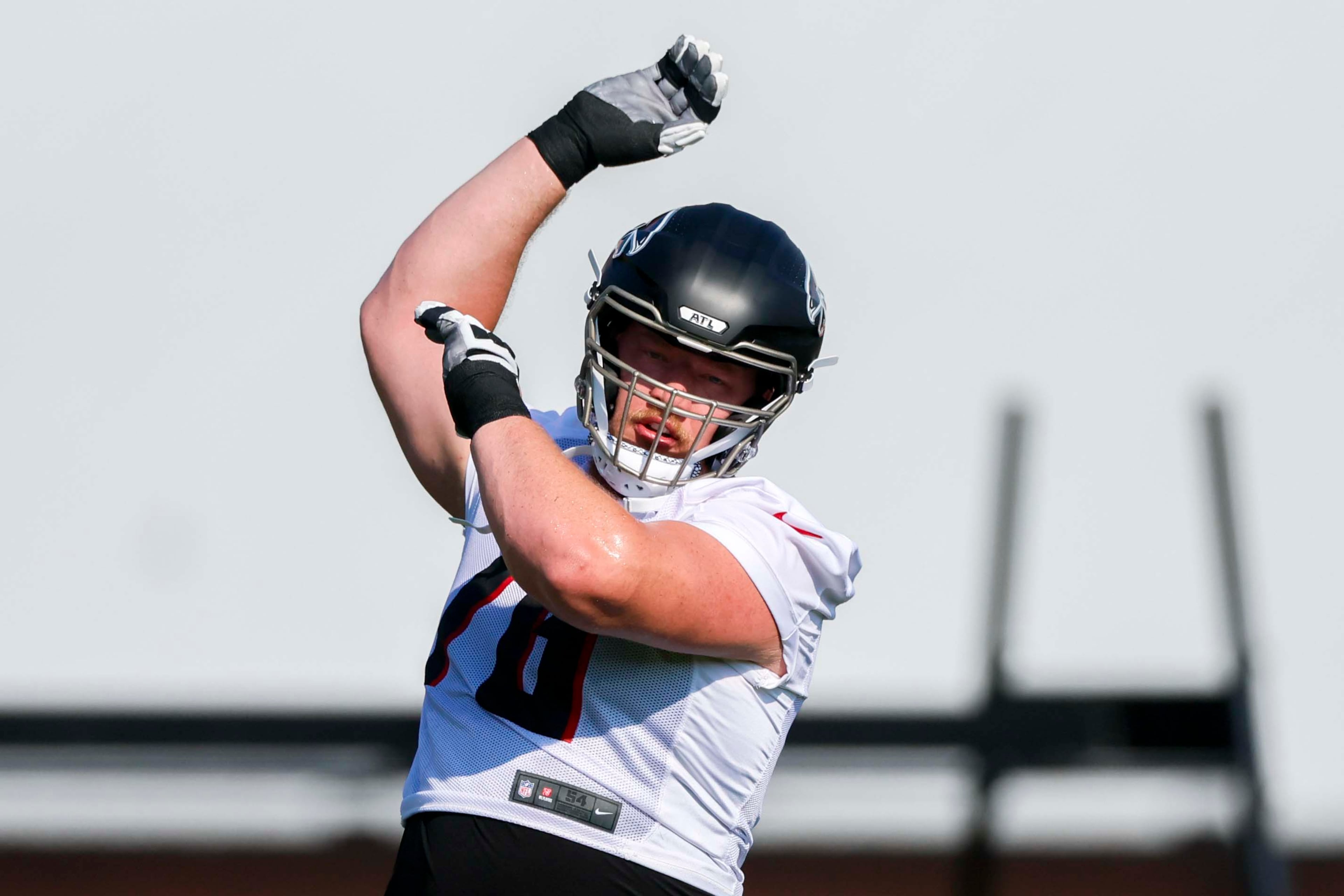 Atlanta Falcons offensive tackle Kaleb McGary stretches during the first training camp practice on Thursday, July 24, 2025, in Flowery Branch. (Miguel Martinez/AJC)