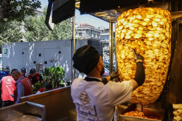 A privately-owned electricity generator, left, stationed outside a restaurant in Damascus, Syria, Monday, July 3, 2025. (AP Photo/Ghaith Alsayed)