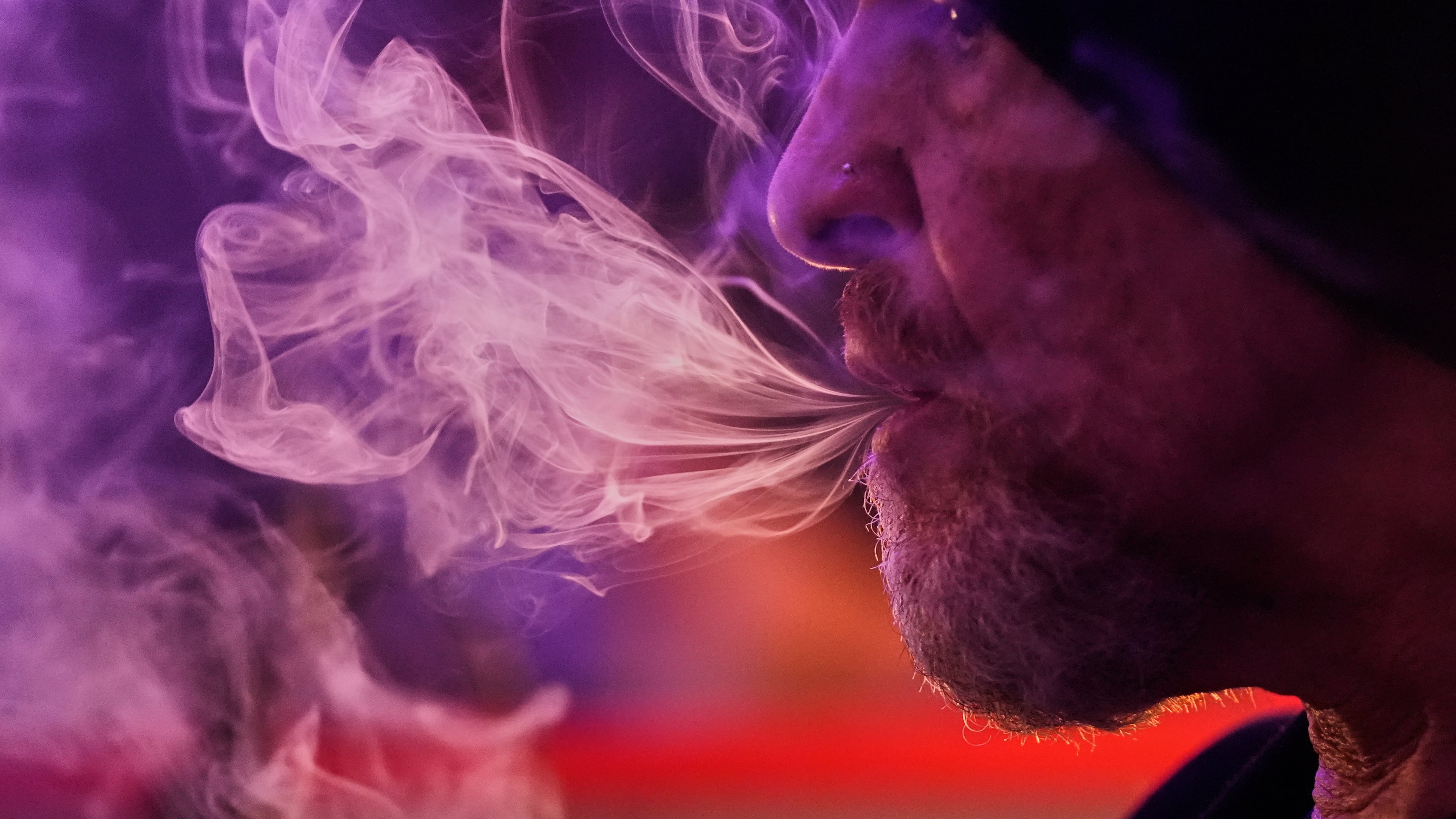 Miguel Laboy smokes cannabis, Oct. 3, 2025, in Brookline, Mass. (AP Photo/Robert F. Bukaty)