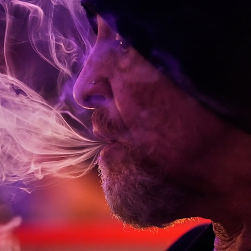 Miguel Laboy smokes cannabis, Oct. 3, 2025, in Brookline, Mass. (AP Photo/Robert F. Bukaty)