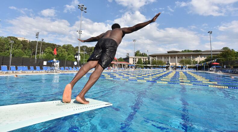 A swimmer jumps off the diving board at the Emory Aquatics Center at the Student Activity and Academic Center on May 10, 2016. The Aquatics Center at the Student Activity and Academic Center is a premier outdoor swimming facility offering its members a wide range of swimming opportunities. HYOSUB SHIN / HSHIN@AJC.COM
