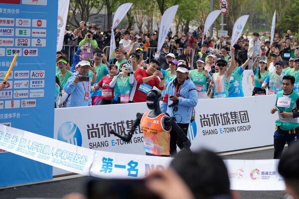 Sky Project Ultra robot crosses the finish line to win the world's first robot half marathon during the Humanoid Robot Half-Marathon held in Beijing on Saturday, April 19, 2025. (AP Photo/Ng Han Guan)