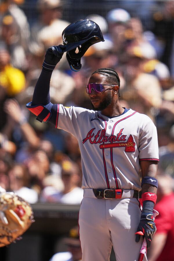 Atlanta Braves' Jurickson Profar acknowledges the crowd as he walks up to bat during the first inning of an opening-day baseball game against his former team, the San Diego Padres, Thursday, March 27, 2025, in San Diego. (AP Photo/Gregory Bull)