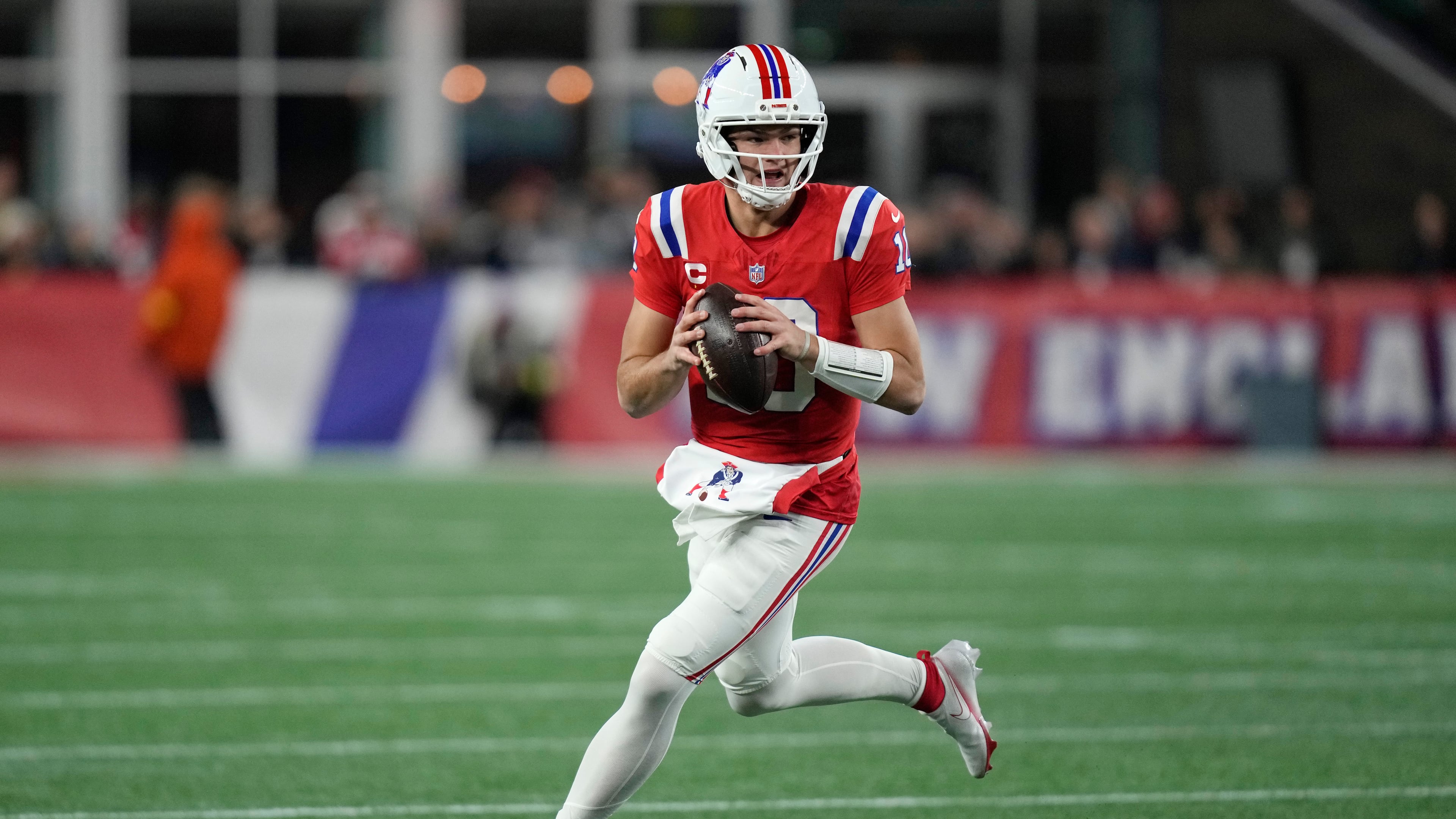 New England Patriots quarterback Drake Maye rolls out during the first half of an NFL football game against the New York Giants, Monday, Dec. 1, 2025, in Foxborough, Mass. (AP Photo/Charles Krupa)