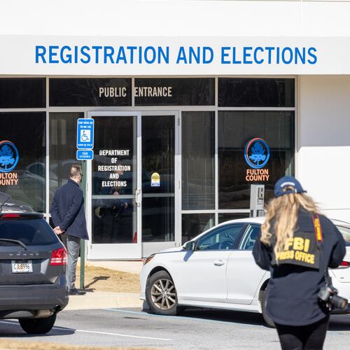 An FBI representative approaches the Fulton County Election Hub and Operation Center in Union City on Wednesday, Jan. 28, 2026. (Arvin Temkar/AJC)