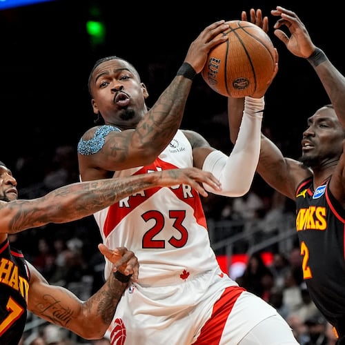 Toronto Raptors guard Jamal Shead (23) drives against Atlanta Hawks guard Keaton Wallace (2) during the first half of an NBA basketball game, Friday, Nov. 7, 2025, in Atlanta. (AP Photo/Mike Stewart)
