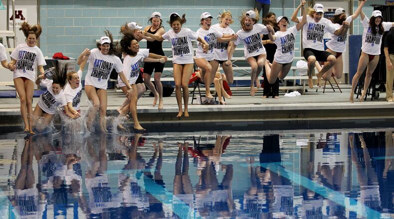 The Georgia women's swim team jumps in a pool after winning the NCAA women's swimming and diving championships in Minneapolis, Saturday, March 22, 2014. (AP Photo/Andy Clayton-King)