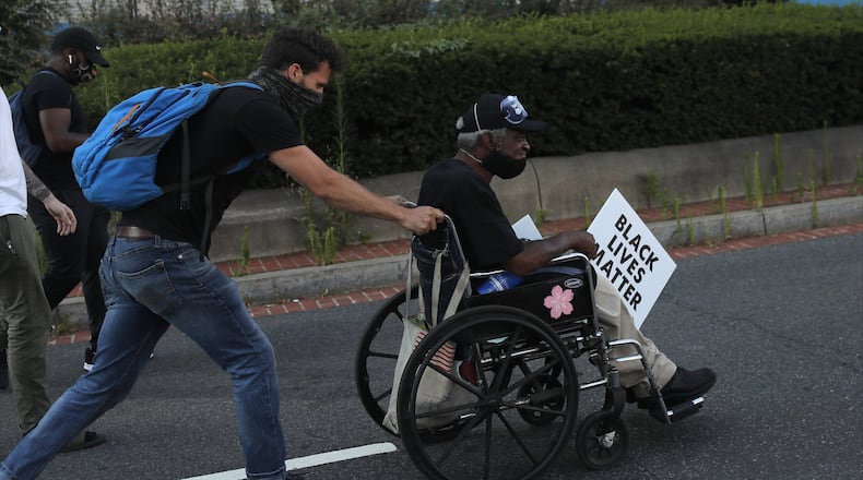 Protesters gather near the White House in Washington, Wednesday, June 24, 2020, amid continuing anti-racism demonstrations following the death of George Floyd, a Black man who was restrained by police in Minneapolis. (AP Photo/Maya Alleruzzo)