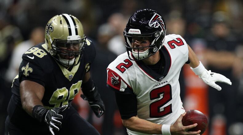 NEW ORLEANS, LA - NOVEMBER 22:  Matt Ryan #2 of the Atlanta Falcons runs with the ball as Sheldon Rankins #98 of the New Orleans Saints defends at the Mercedes-Benz Superdome on November 22, 2018 in New Orleans, Louisiana.  (Photo by Chris Graythen/Getty Images)