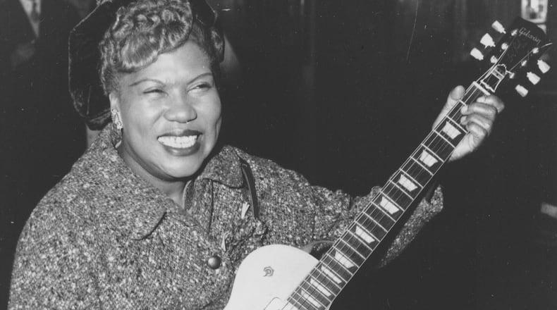 Sister Rosetta Tharpe, guitar-playing American gospel singer, gives an impromptu performance in a lounge at London Airport, following her arrival from New York on Nov. 21, 1957. AP PHOTO